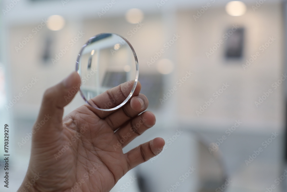 Fototapeta premium close up of a hand holding a glasses lense