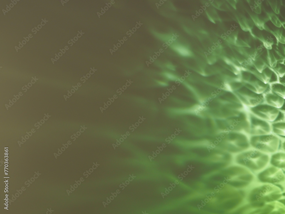 Green reflections from glass on a white background at night for a minimalist background.     