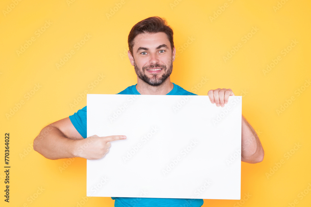 Information concept. Man with blank placard. Demonstrating copy space for your text or design. Man showing empty advertisement board on studio background. Blank placard, signboard for ad. Information concept. Man with blank placard. Demonstrating copy space for your text or design. Man showing empty advertisement board on studio background. Blank placard, signboard for ad.