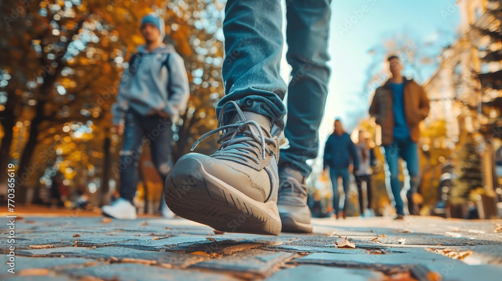 A diverse group of individuals, including a man, walking down a busy city sidewalk amidst urban buildings A diverse group of individuals, including a man, walking down a busy city sidewalk amidst urban buildings