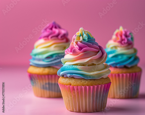 Cupcakes adorned with vibrant, rainbow-like frosting