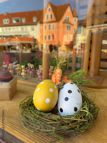 window of a toy shop decorated with for easter with colorful eggs