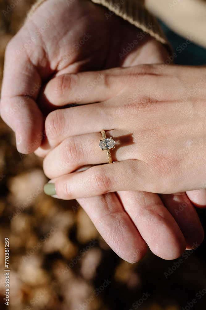 engaged couple showing diamond ring with gold band after proposal engaged couple showing diamond ring with gold band after proposal