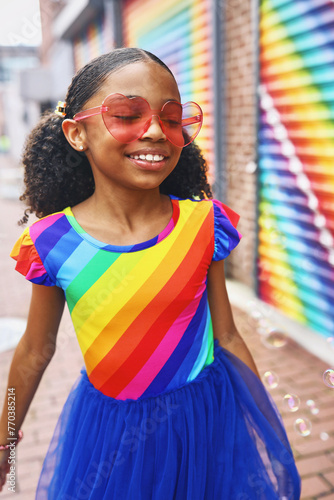Young Girl smiling with bubbles in front of a mural in Washington, DC photo