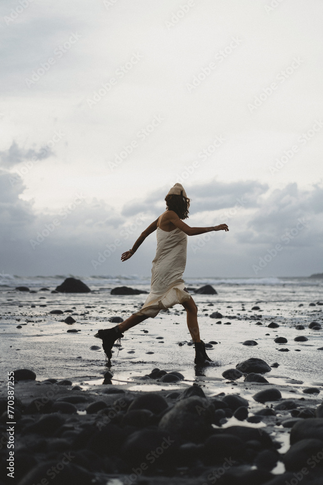 Young woman on the beach at sunset, Medewi Young woman on the beach at sunset, Medewi