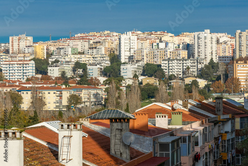 Lisbon, Portugal. 11 December 2023. Cityscape of Queluz and Monte Abraão. Flats and houses with a cloudy blue sky. photo