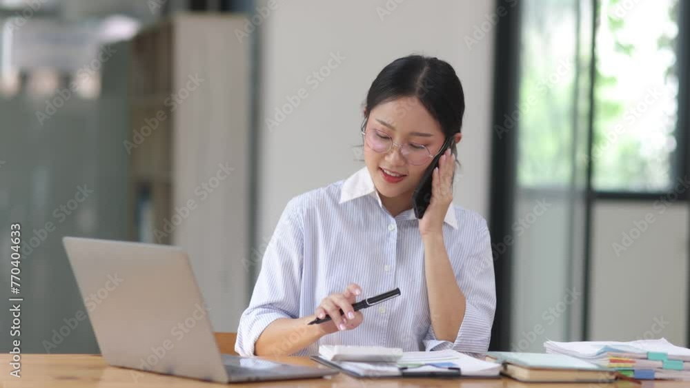 Businesswoman using a smartphone at the office. Businesswoman using a smartphone at the office.