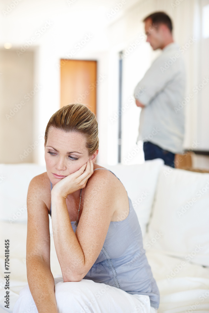 Divorce, thinking and woman in home for conflict, crisis or fight in living room. Couple, breakup and sad people with depression, anger or frustrated with stress in argument for marriage fail on sofa Divorce, thinking and woman in home for conflict, crisis or fight in living room. Couple, breakup and sad people with depression, anger or frustrated with stress in argument for marriage fail on sofa