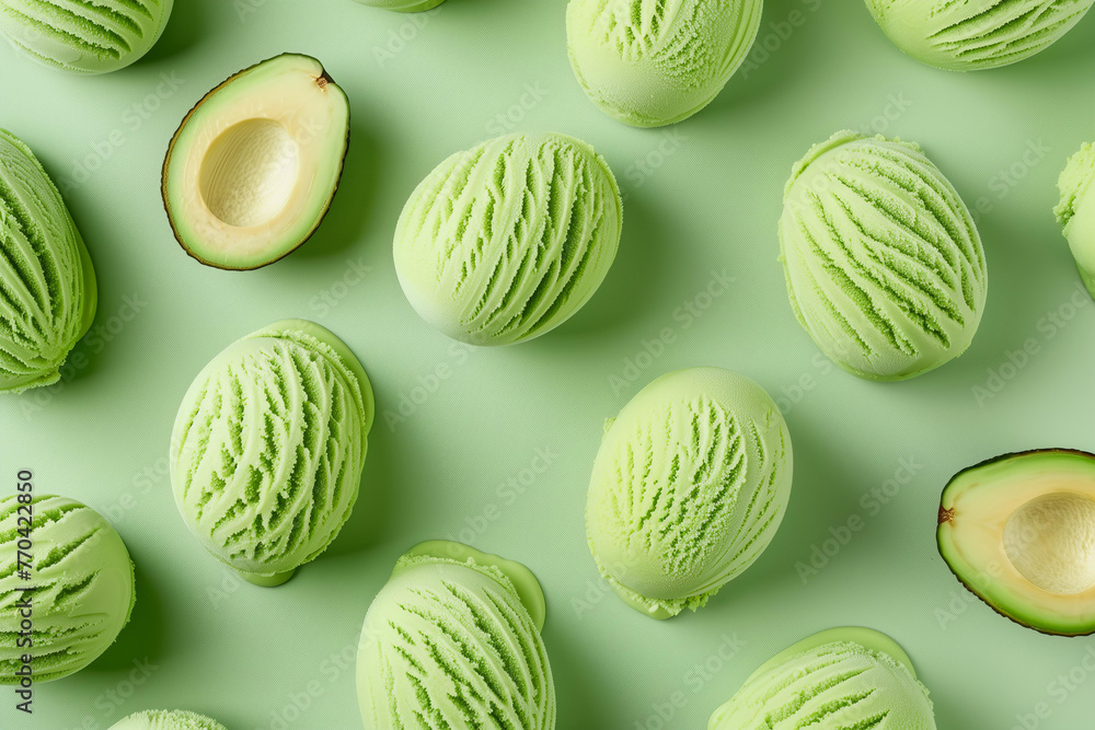 A pattern of scooped avocado ice cream , top view on pastel green background A pattern of scooped avocado ice cream , top view on pastel green background