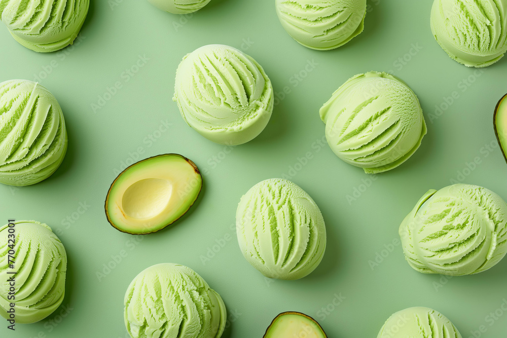 A pattern of scooped avocado ice cream , top view on pastel green background A pattern of scooped avocado ice cream , top view on pastel green background