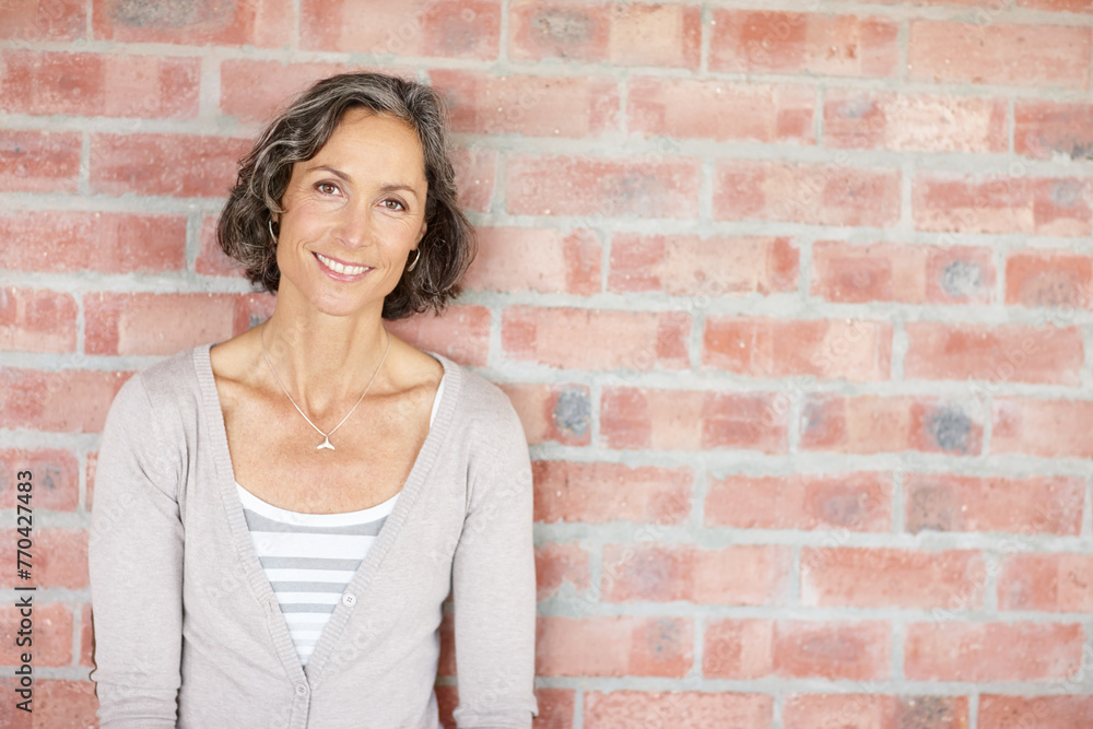 Portrait, brick wall or woman in architecture, business or agency as creative entrepreneur project. Mature, female architect or smile at professional, urban planning or career at industrial workplace Portrait, brick wall or woman in architecture, business or agency as creative entrepreneur project. Mature, female architect or smile at professional, urban planning or career at industrial workplace