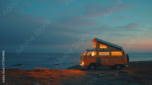 Camper van at seaside beach at night. Cozy atmosphere and lighting from inside the van. Calm. Zen. Travel. Tourism. 