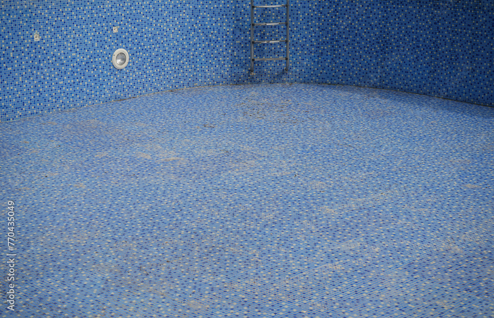 bottom of dirty leaking swimming pool removing water so the pool can be ...