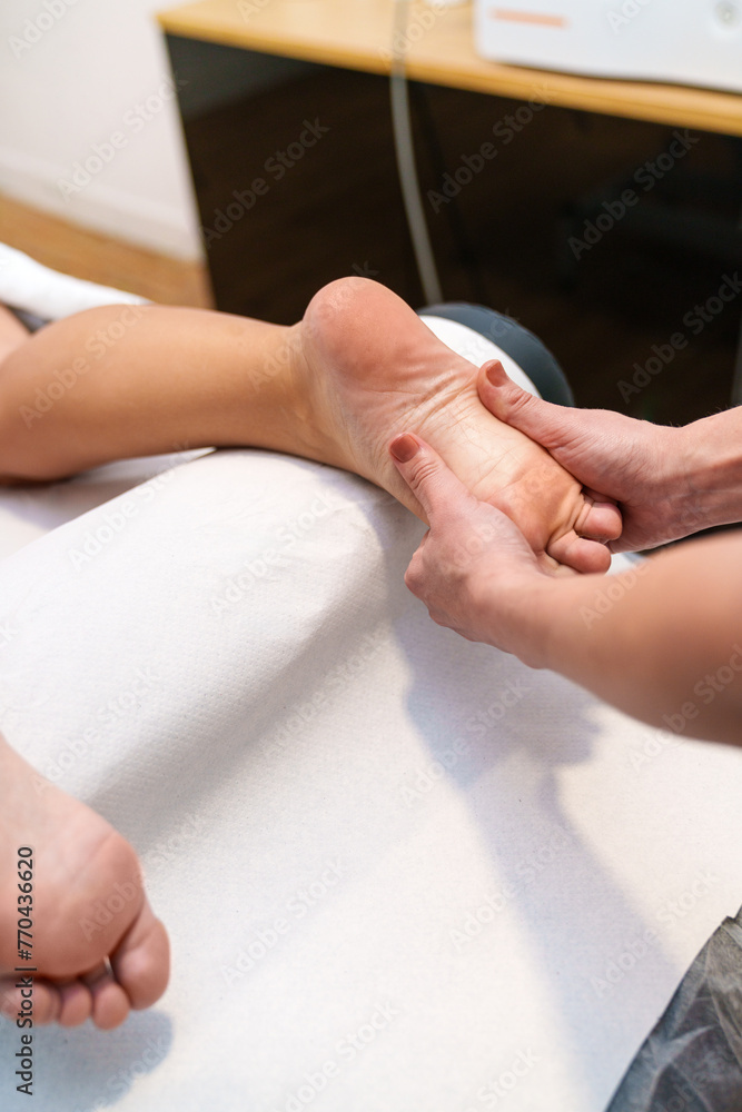 A therapist applies a foot stretch massage.