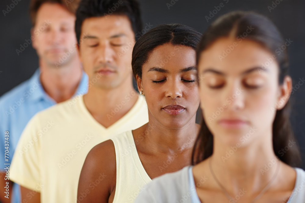 Diversity, people and row with eyes closed for meditation in dark background for peace, calm and healthy mind. Group, standing and concentrate at yoga for health or hobby with friendship and wellness