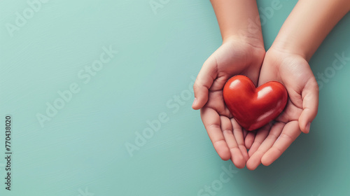 A heart held in both hands, symbolizing love on a blue background