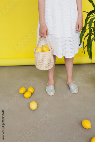 lemons in a basket in a studio with white background