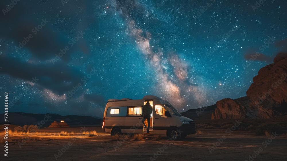 Camper van parked at night in national park. Milky way in the night sky. Outdoors. Adventure. Travel. Atmospheric ambient lighting. Van life. Explorers.	