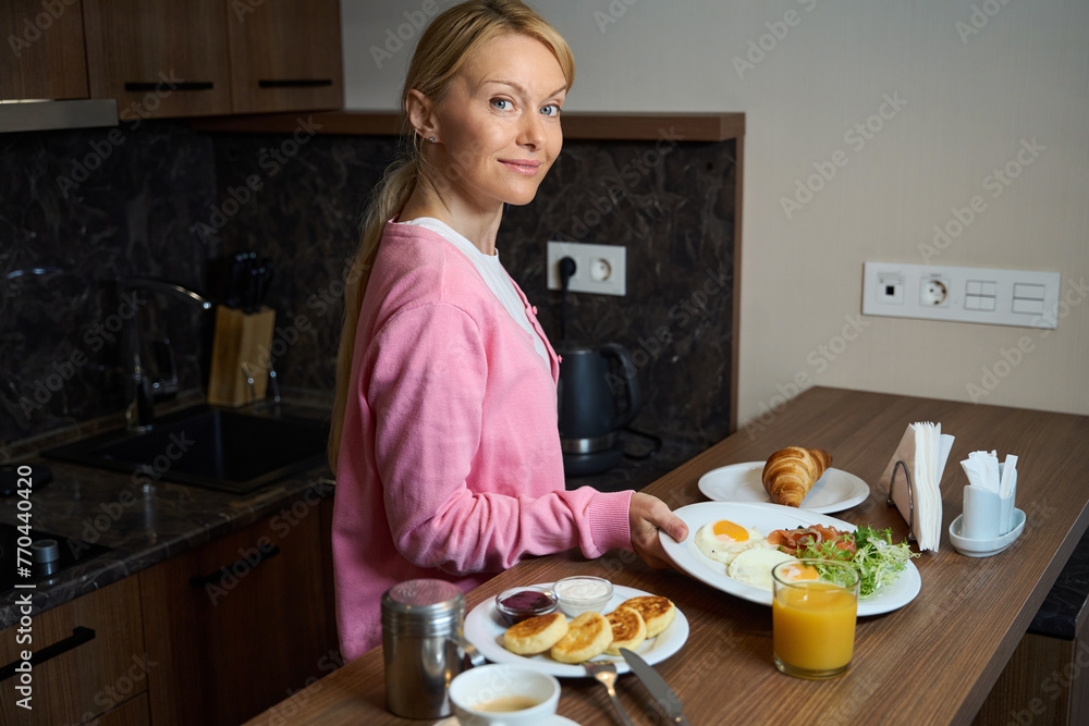 Smiling lady preparing for eating morning meal