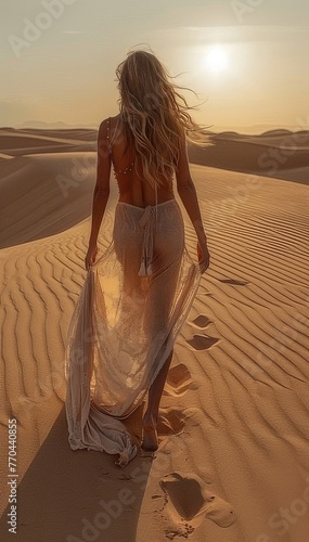 Woman in amazing silk wedding dress with fantastic view of Sahara desert sand dunes in sunset light concept