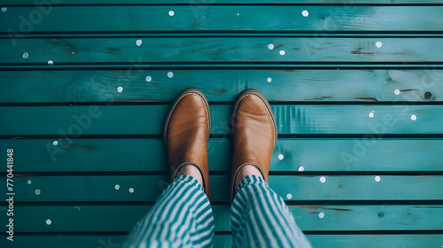 woman's feet with white nail polish on her toes, standing barefoot in the middle of an old blue wooden floor