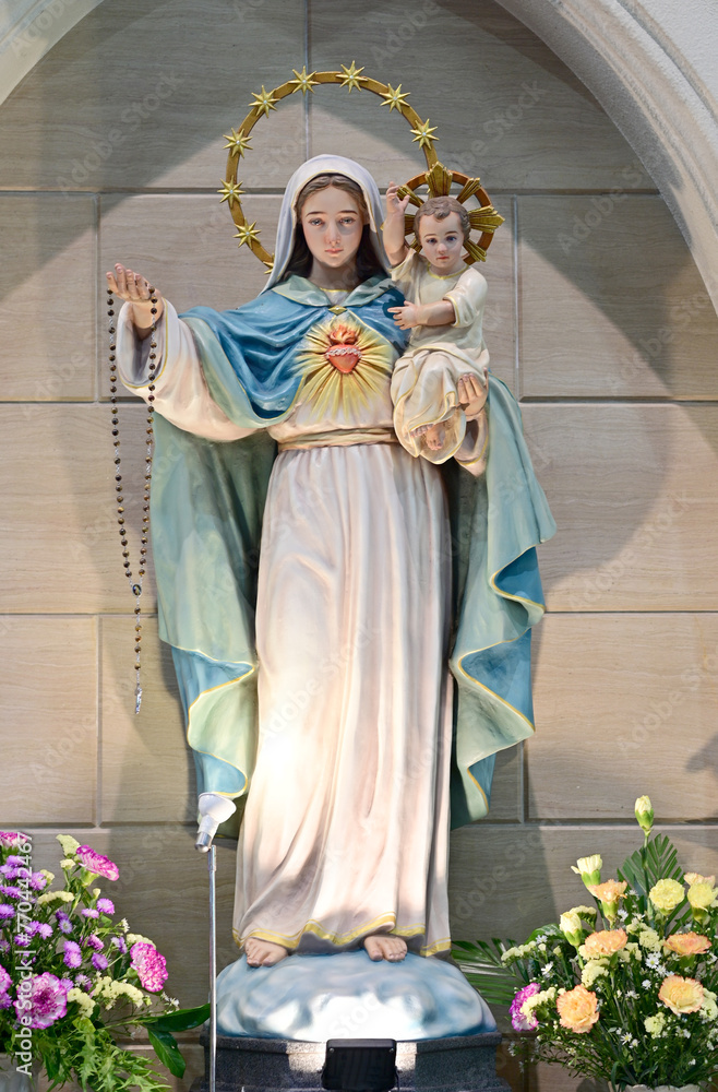 custom made wallpaper toronto digitalCloseup of Statue of Our lady virgin Mary with Child Jesus located in front of the catholic church with natural background, Thailand. selective focus.