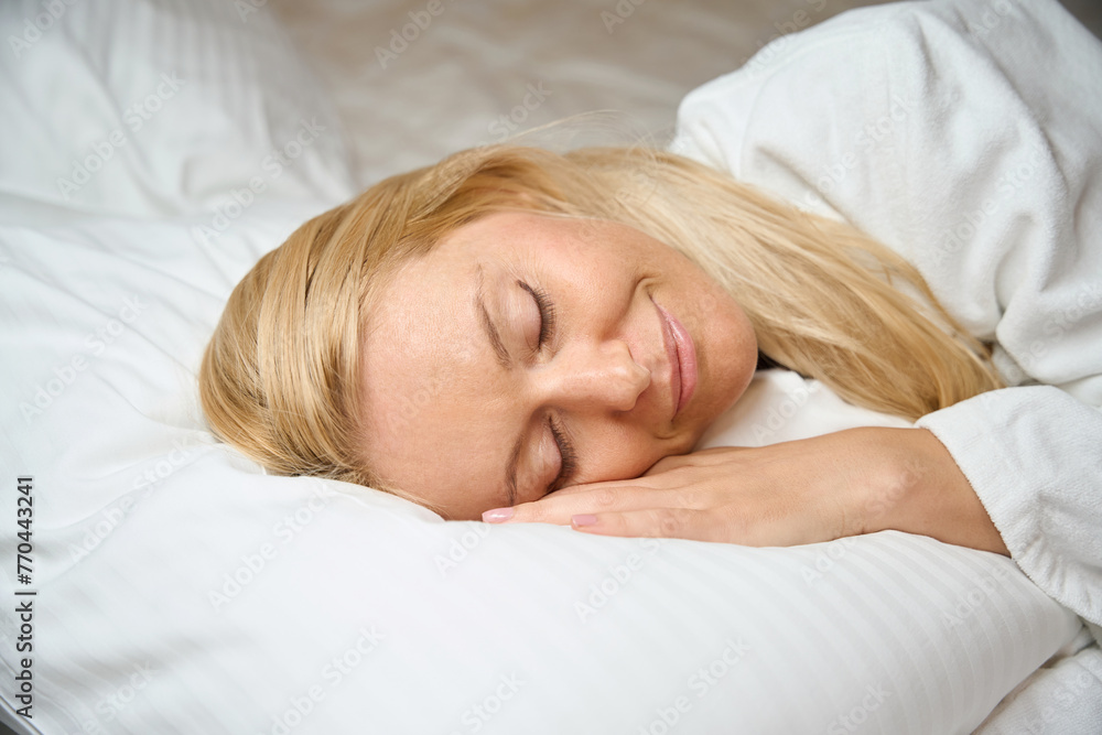 Calm young female is sleeping peacefully in her bedroom Calm young female is sleeping peacefully in her bedroom