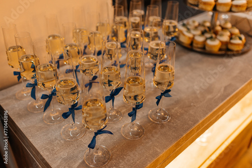 glasses with white champagne on table for guests of the event, out catering