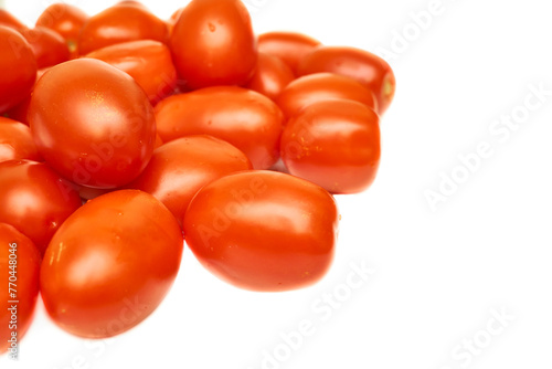 Pile of ripe red delicious tomatoes for cooking on white