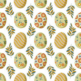 Painted Easter eggs, spring twigs and leaves form a seamless pattern on a white background for textile and wrapping paper. 