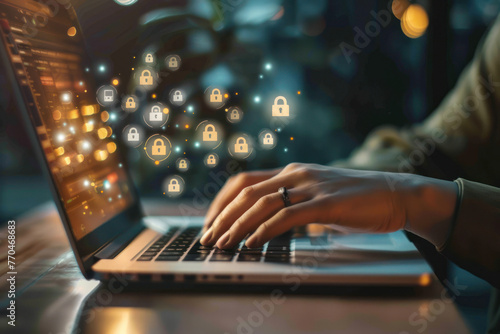 Person typing on a laptop at night with glowing security icon concept photo