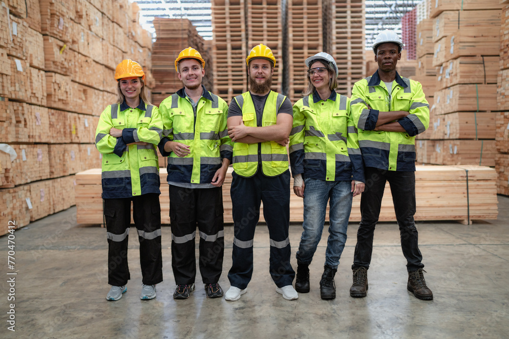Group of diverse workers in safety uniform standing together in storehouse. Multicultural team working in logistic distribution warehouse. Caucasian and multiracial foreman people teamwork industrial.