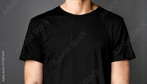 A t-shirt mockup featuring a man in a black shirt, ideal for showcasing graphic designs or fashion branding against a dark backdrop. photo