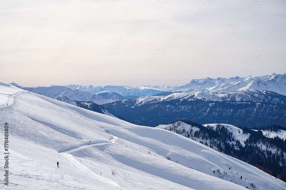 Expansive winter Mountain vista under a pale sky. Expansive winter Mountain vista under a pale sky.