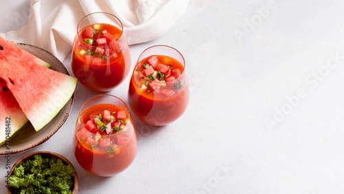 фотографія Spanish tomato and watermelon gazpacho cold soup styled and decorated in glasses