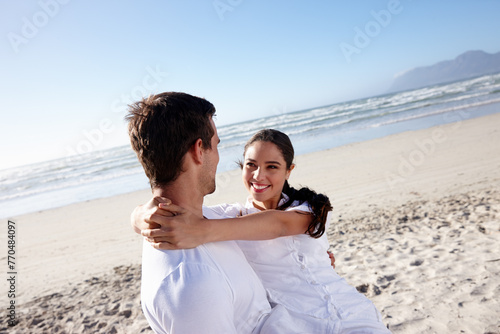 Happy, beach and man carry woman for bonding, relax together and relationship by ocean. Dating, travel and man and woman embrace for romance on holiday, vacation and weekend in nature together