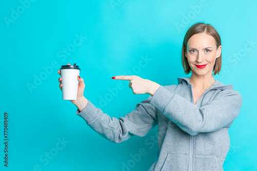 Sexy Female Girl Hand Pointing with Finger Cup of Coffee Drink Isolated on Vivid Trendy Turquoise background.