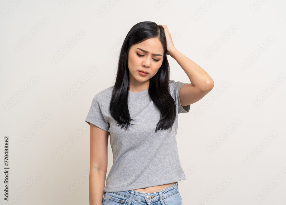 Young asian unwell unhealthy woman hand touching head she's feeling depressed stress headache be tired from working standing on isolated white background she has symptom office syndrome. Young asian unwell unhealthy woman hand touching head she's feeling depressed stress headache be tired from working standing on isolated white background she has symptom office syndrome.