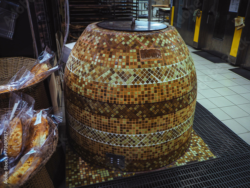 outside view on tandoor in supermarket. Traditional way of baking bread in the tandoor in Middle Asia, Dagestan, Russia.