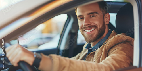 Cheerful male driver going on a road trip. Attractive handsome man riding a car. Person holding steering wheel.