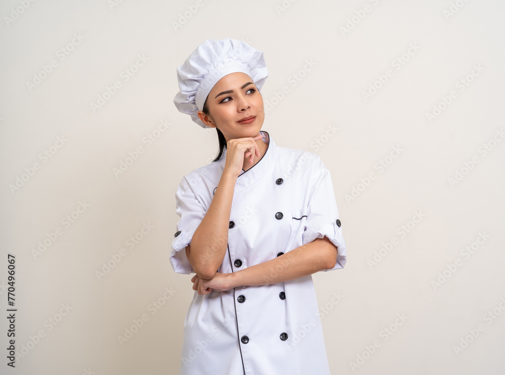 Thinking menu Young beautiful asian woman chef in uniform on isolated background. Cooking woman Occupation chef or baker People in kitchen restaurant and hotel. Thinking menu Young beautiful asian woman chef in uniform on isolated background. Cooking woman Occupation chef or baker People in kitchen restaurant and hotel.