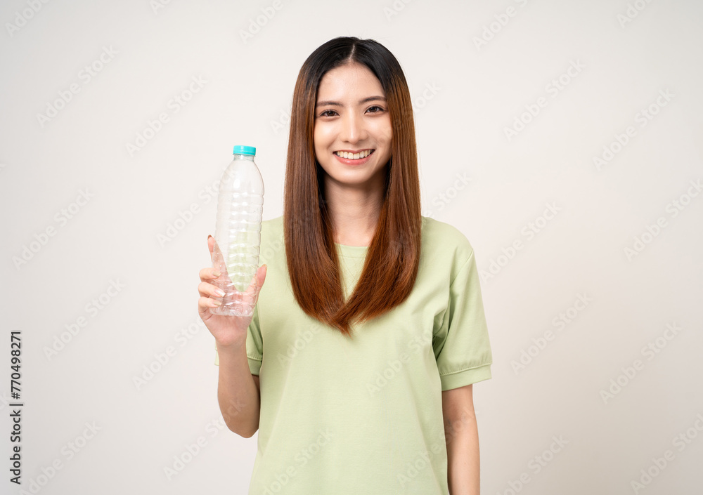 Young asian beautiful woman holding plastic of bottle assume Garbage sorting before throwing them into the bin. Activist environmental woman in green shirt with recycle and sustainability concept. Young asian beautiful woman holding plastic of bottle assume Garbage sorting before throwing them into the bin. Activist environmental woman in green shirt with recycle and sustainability concept.