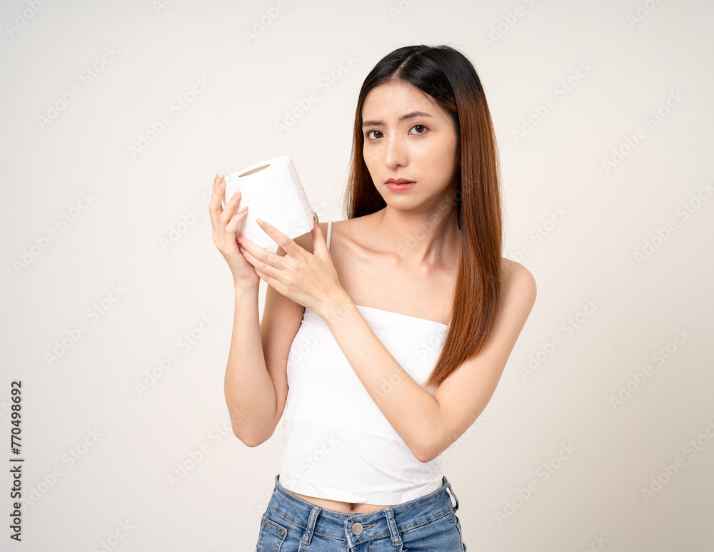 Beautiful young asian woman holding tissue paper go to toilet. Charming female lady standing pose with tissue paper on isolated white background.