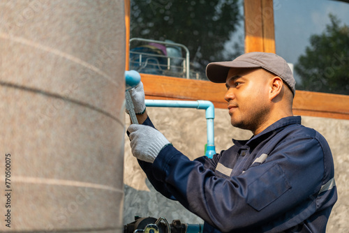 Male Plumber worker installation pipe system hand holding the water tap faucet. Plumbing checking service and repair.