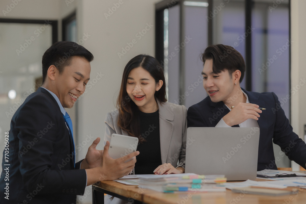 A group of employees happily work together in the office while discussing work that was completed on time as ordered by their boss, A group of entrepreneurs had fun working together. A group of employees happily work together in the office while discussing work that was completed on time as ordered by their boss, A group of entrepreneurs had fun working together.