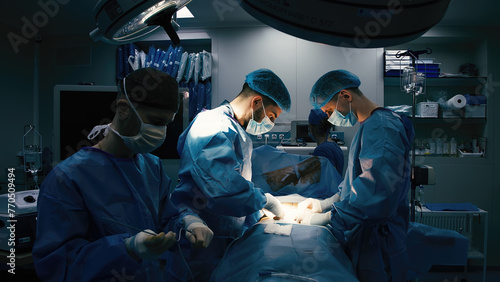 Close-up of surgeons in protective clothing in a modern operating room. Healthcare, surgery and cosmetic surgery concept. photo