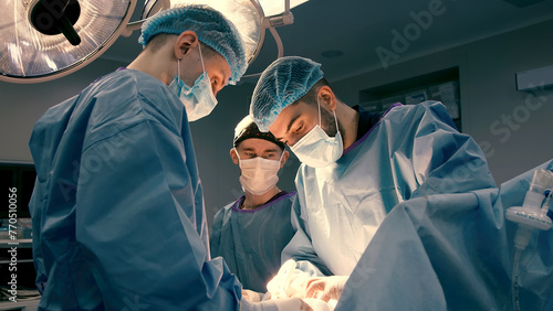 A group of professional surgeons in the operating room. Close-up of a surgical operation. Plastic surgery. Health. Surgery in a private clinic. Beauty and health.