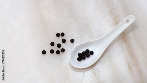 Картината върху платно White soup spoon, with traditional Chinese medicine in form of small black balls