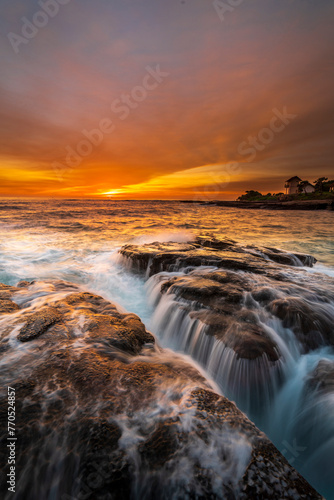 dramatic view and amazing sea view at golden hour and beautiful sunset view with a reddish orange sky at Cicalobak beach in Garut, West Java