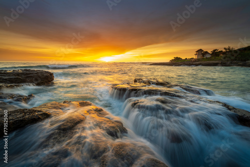 dramatic view and beautiful sunset view with a reddish orange sky at Cicalobak beach in Garut, West Java